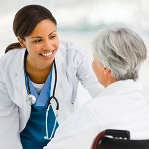 Healthcare professional talking warmly with an older adult about everyday wellness habits